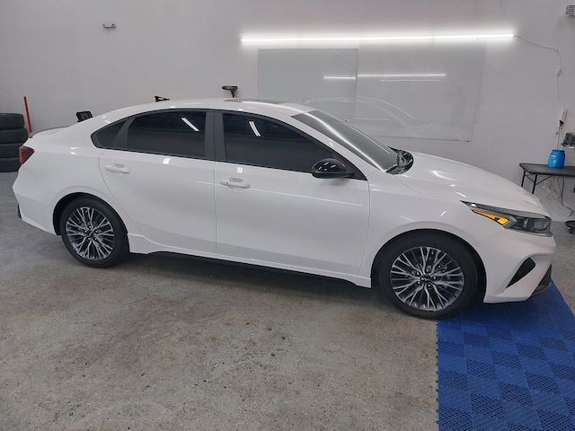 A white car is parked in a garage.