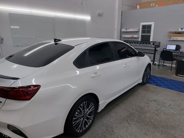 A white car is parked in a garage.