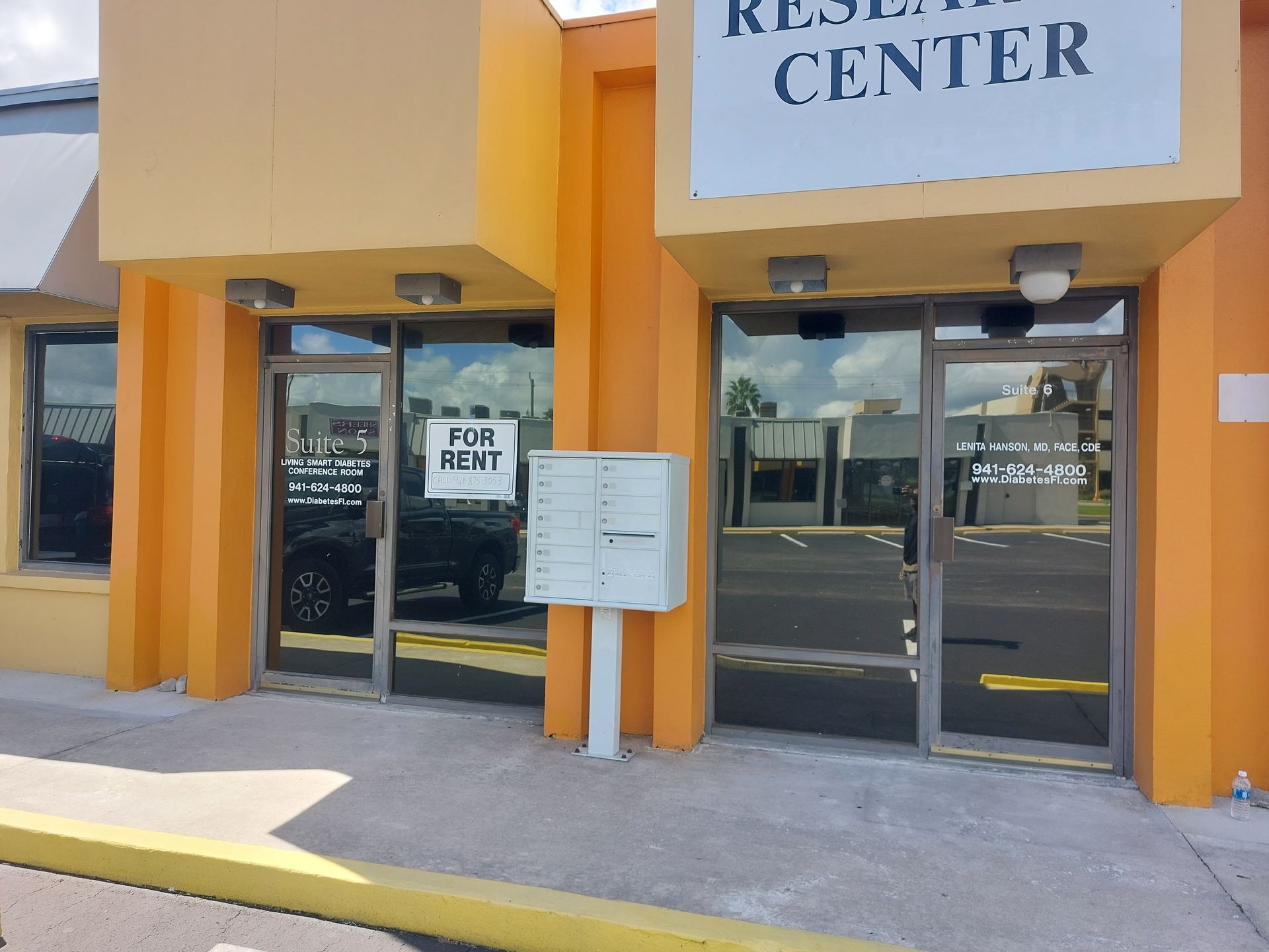 A building with a sign that says ' for rent ' on it