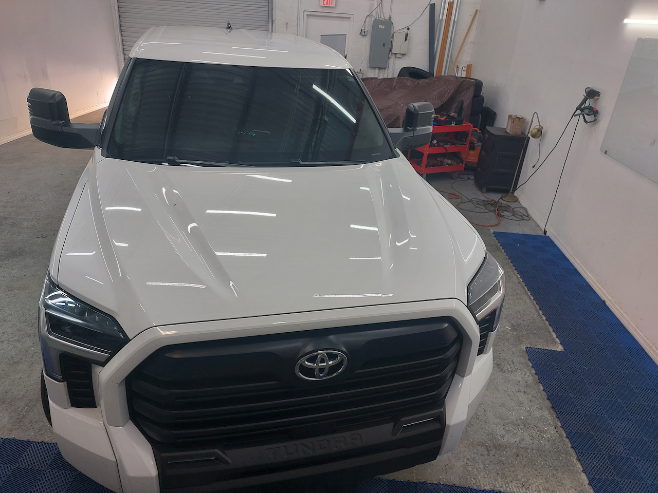 A white toyota truck is parked in a garage