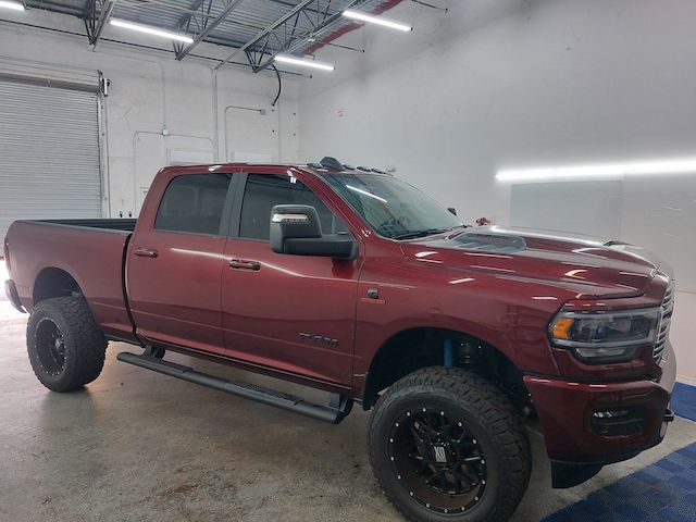 A red ram truck is parked in a garage.