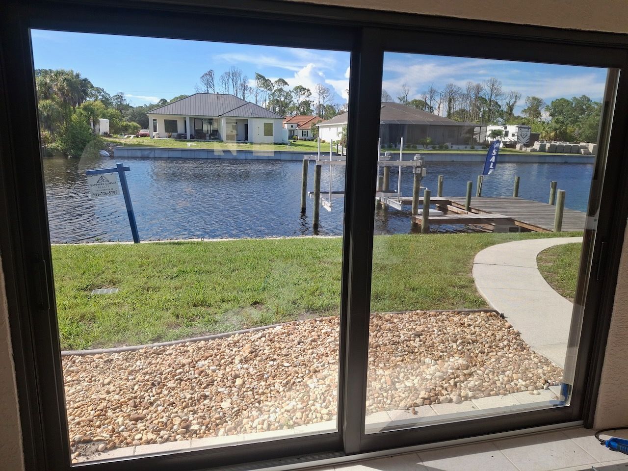 A view of a lake through a sliding glass door