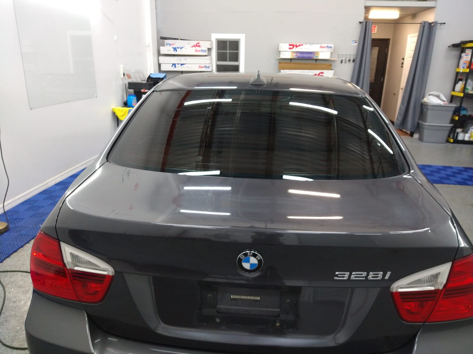A gray bmw is parked in a garage