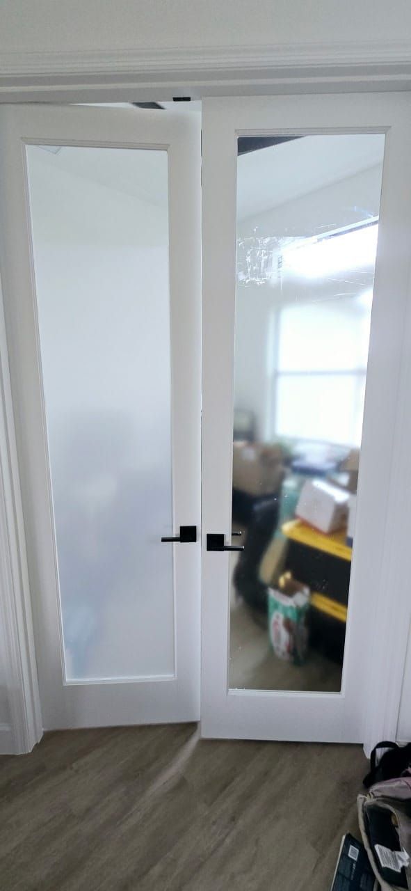 A white door with a glass door in a room.