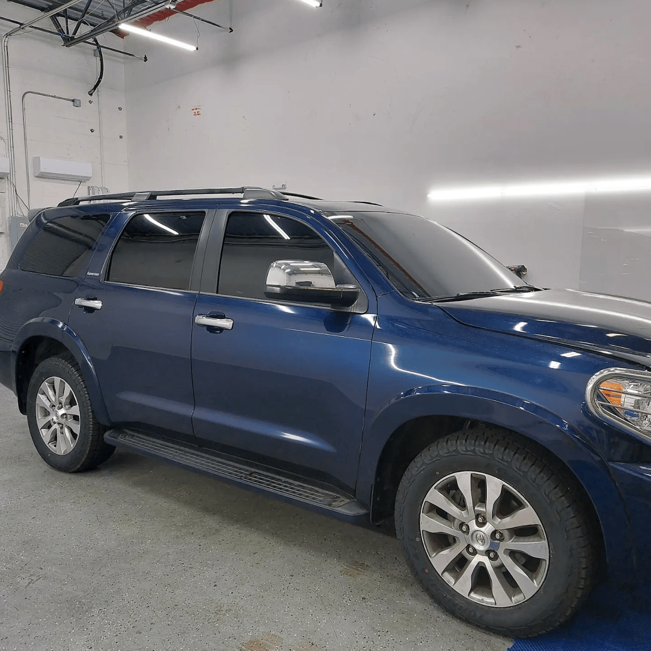A blue suv is parked in a garage