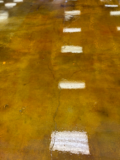 A close up of a concrete floor with a lot of lights on it.