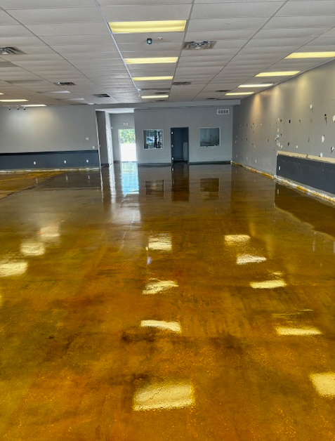 A large empty room with a shiny concrete floor.