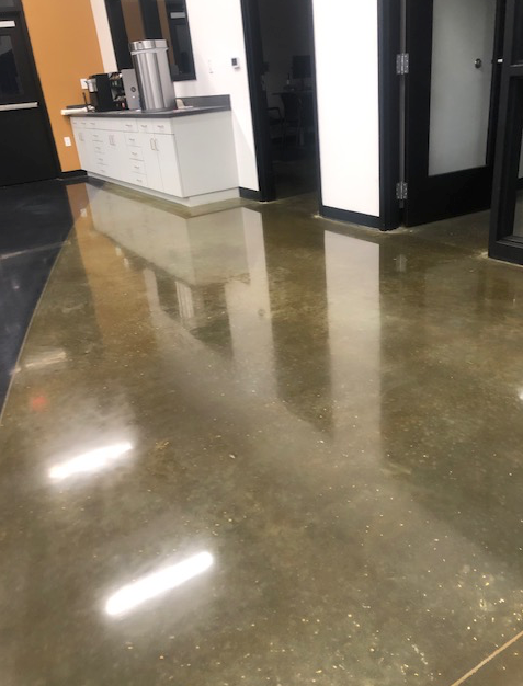 A shiny concrete floor with a counter in the background
