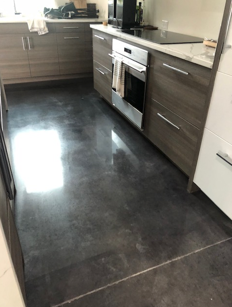 A kitchen with stainless steel appliances and a black floor