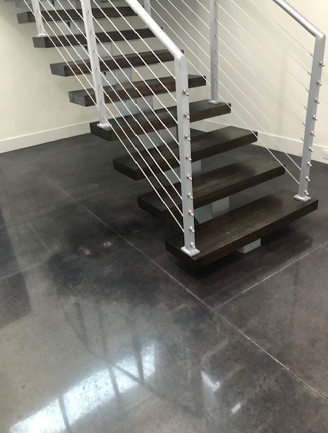 A staircase with a metal railing and wooden steps