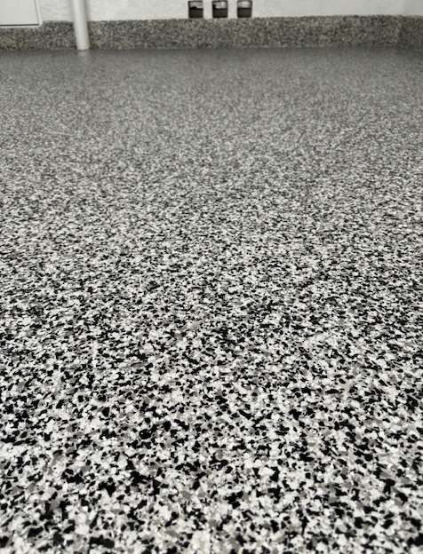 A close up of a black and white marble floor.
