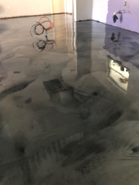 A close up of a shiny metallic floor in a room.