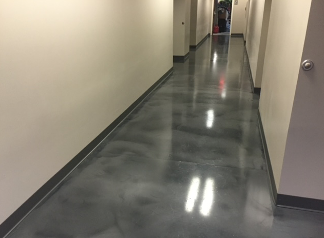A long hallway with a shiny gray floor and white walls.