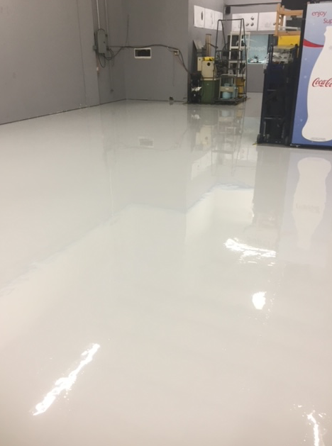 A white floor in a room with a snowman in the background.