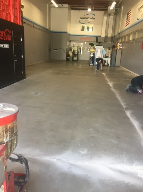A man is kneeling on the floor of a building.