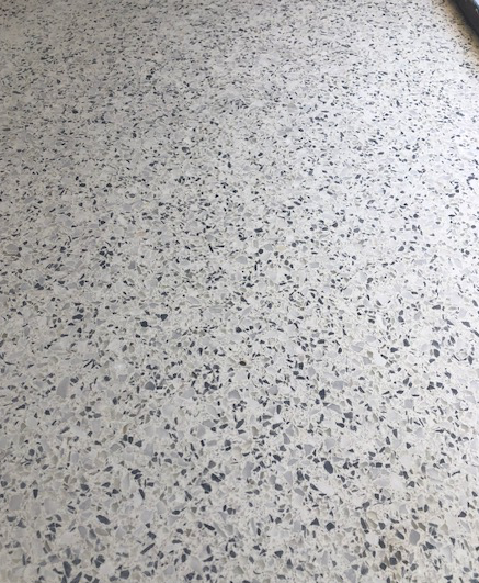 A close up of a white and gray granite floor.