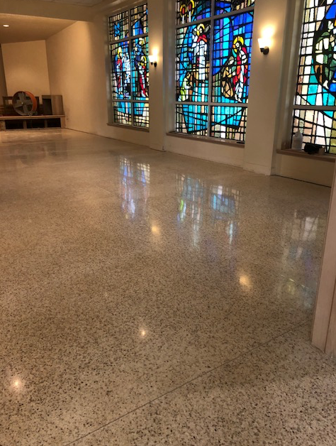 A room with stained glass windows and a shiny floor