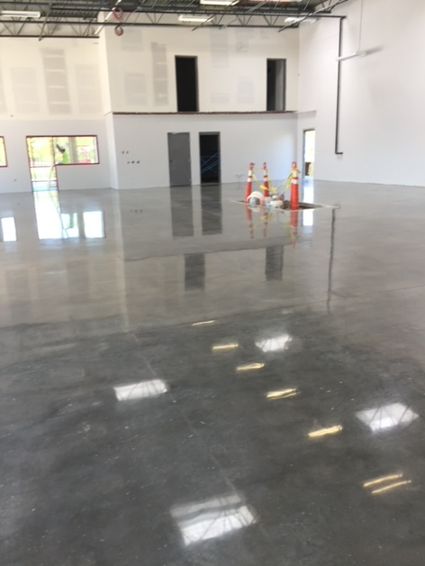 A large empty room with a shiny concrete floor