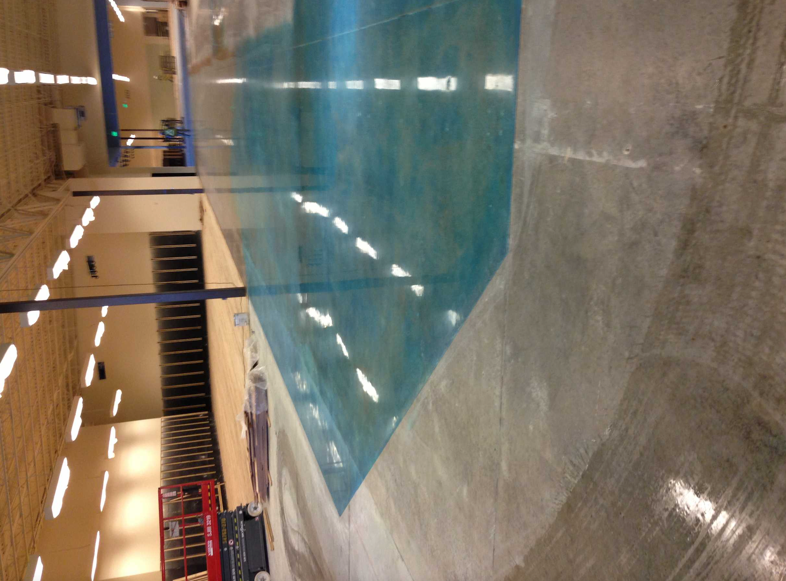 A large indoor swimming pool with blue water