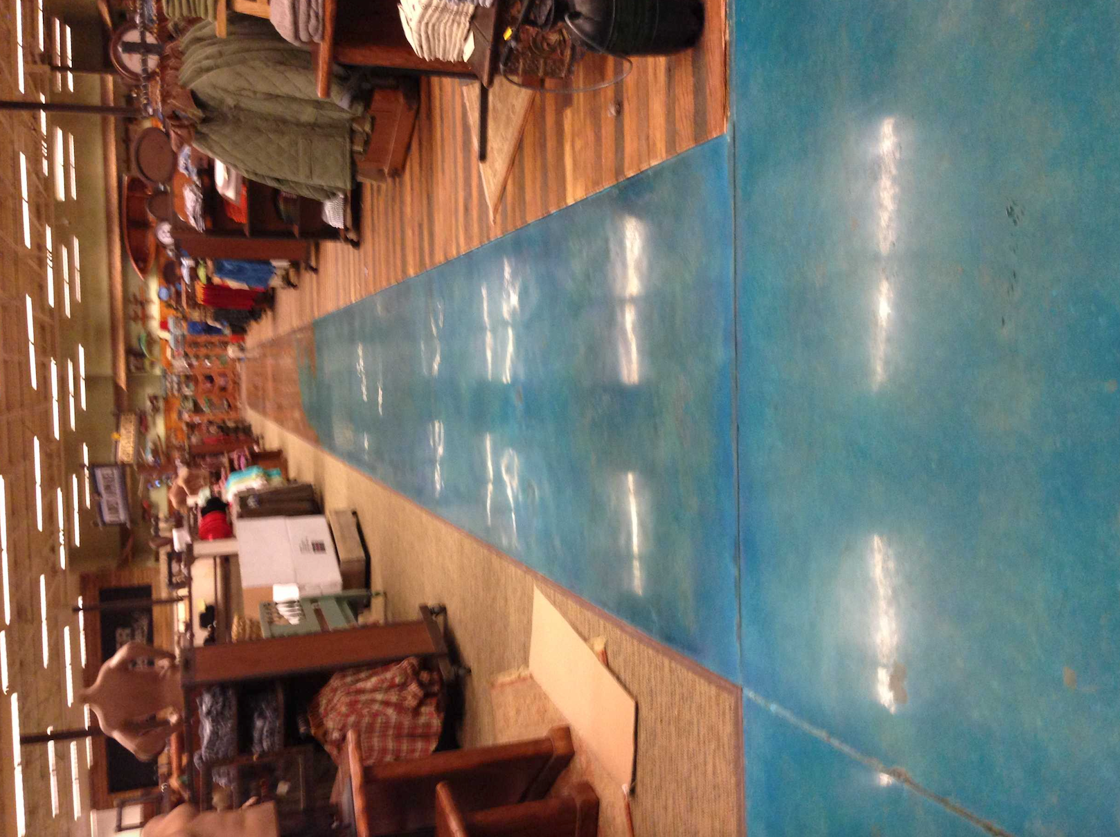 A long blue carpet runs through a store