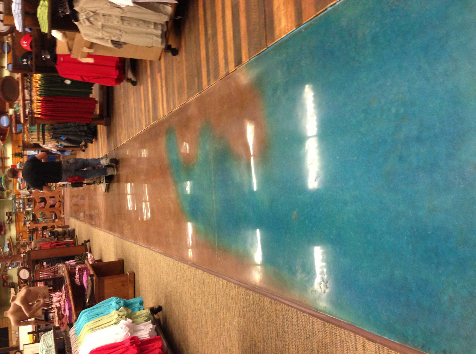 A person is walking down a hallway in a store