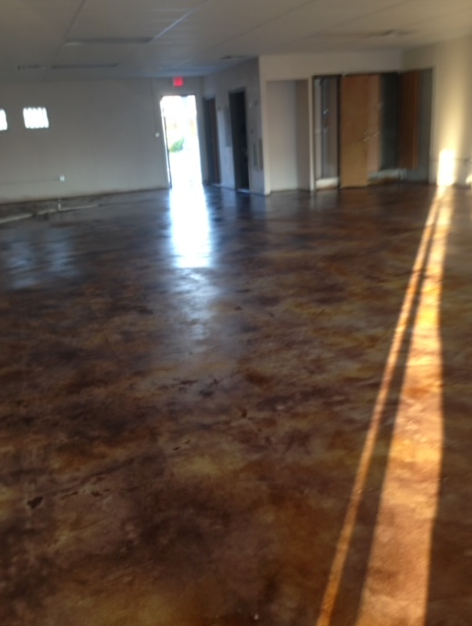 A large empty room with a concrete floor