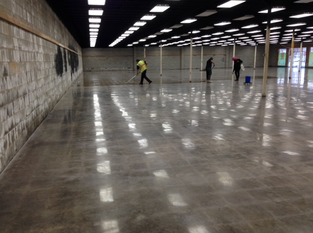 A group of people are cleaning the floor of a building