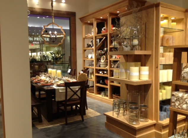 A dining room in a store with a table and chairs