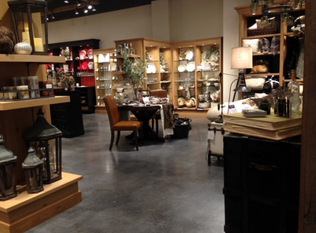 A store filled with furniture and lanterns including a table and chairs