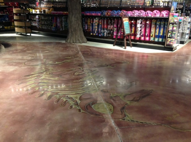 The floor of a store with a painting of a tree on it.
