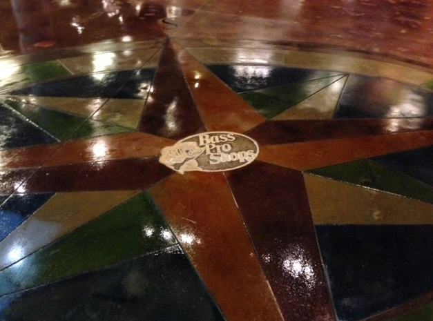 A compass on a wooden floor that says miss the slopp