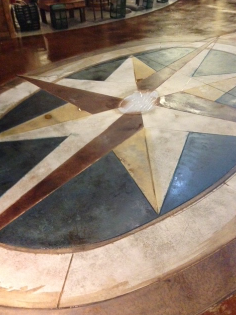 A compass on the floor of a building