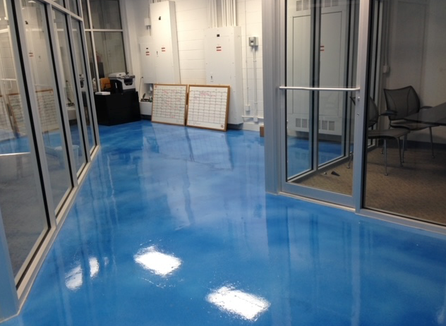A room with a blue floor and a glass door.