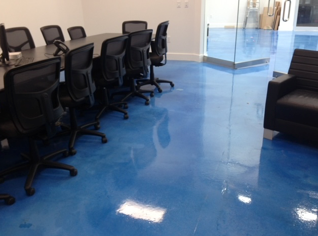 A conference room with blue floors and black chairs