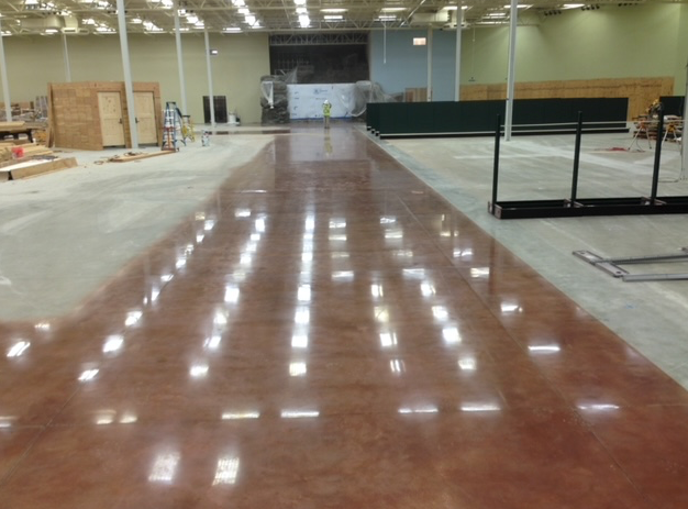 A large warehouse with a shiny concrete floor