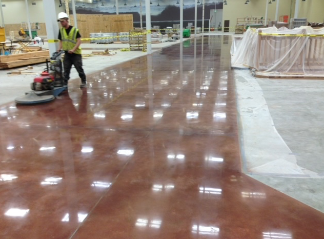 A man is polishing the floor of a building