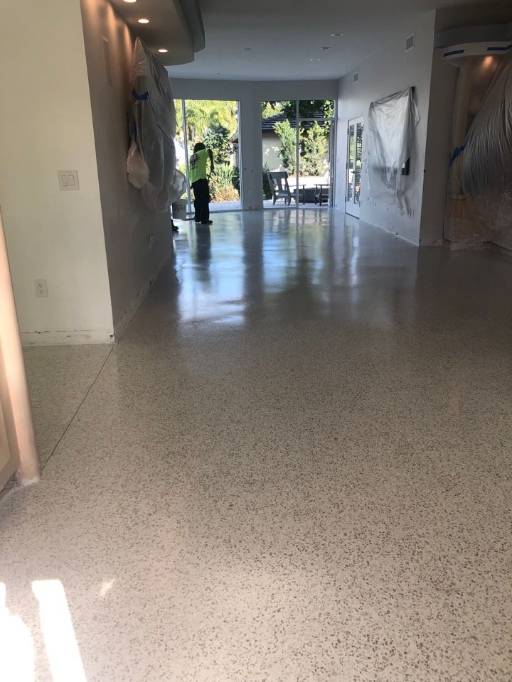 A man is cleaning the floor of a house.