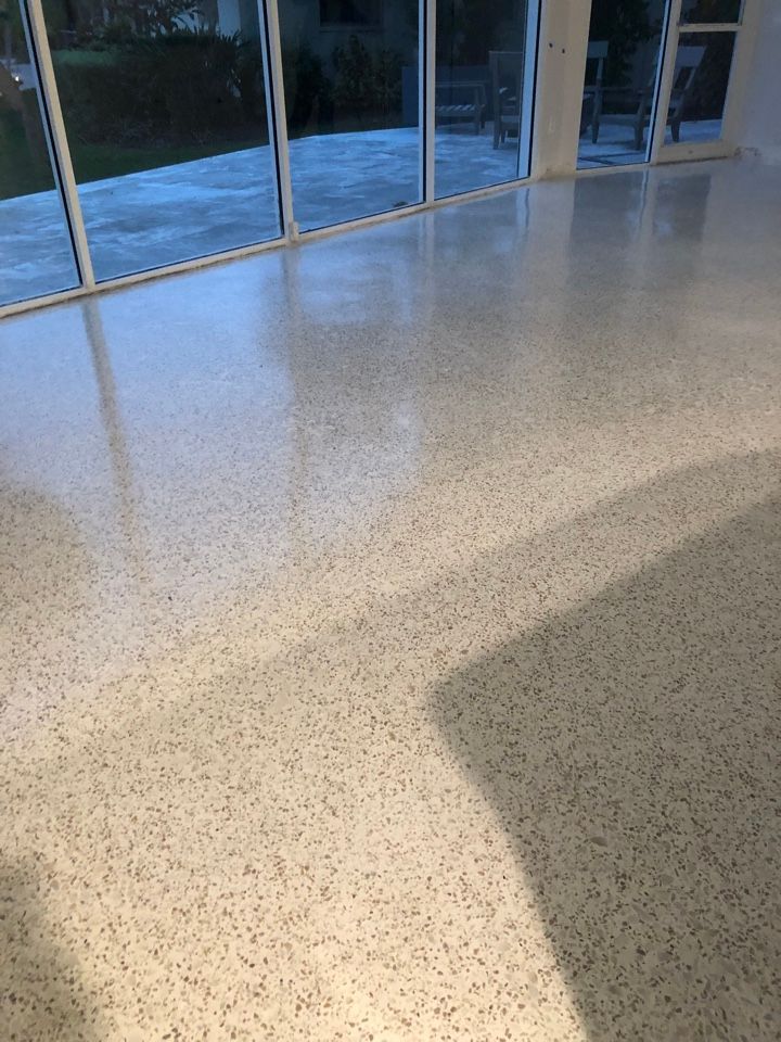 A room with a white floor and sliding glass doors