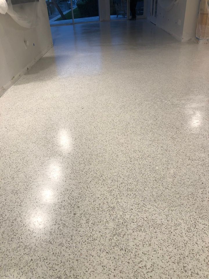A white floor with a lot of small stones on it.