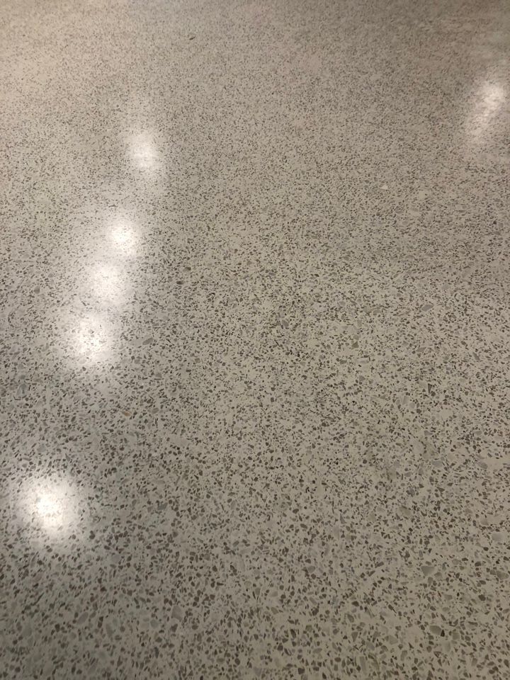A close up of a shiny concrete floor with a lot of small dots on it.