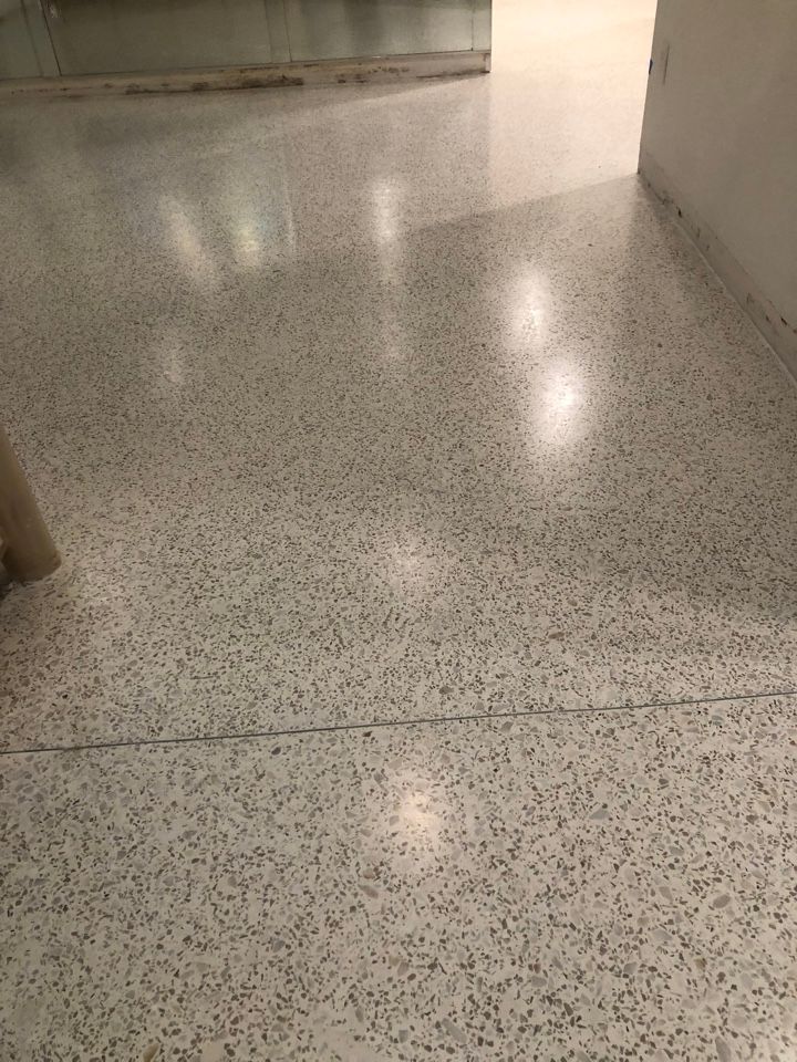A close up of a white tiled floor in a room.