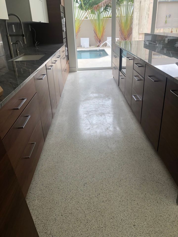 A kitchen with a swimming pool in the background