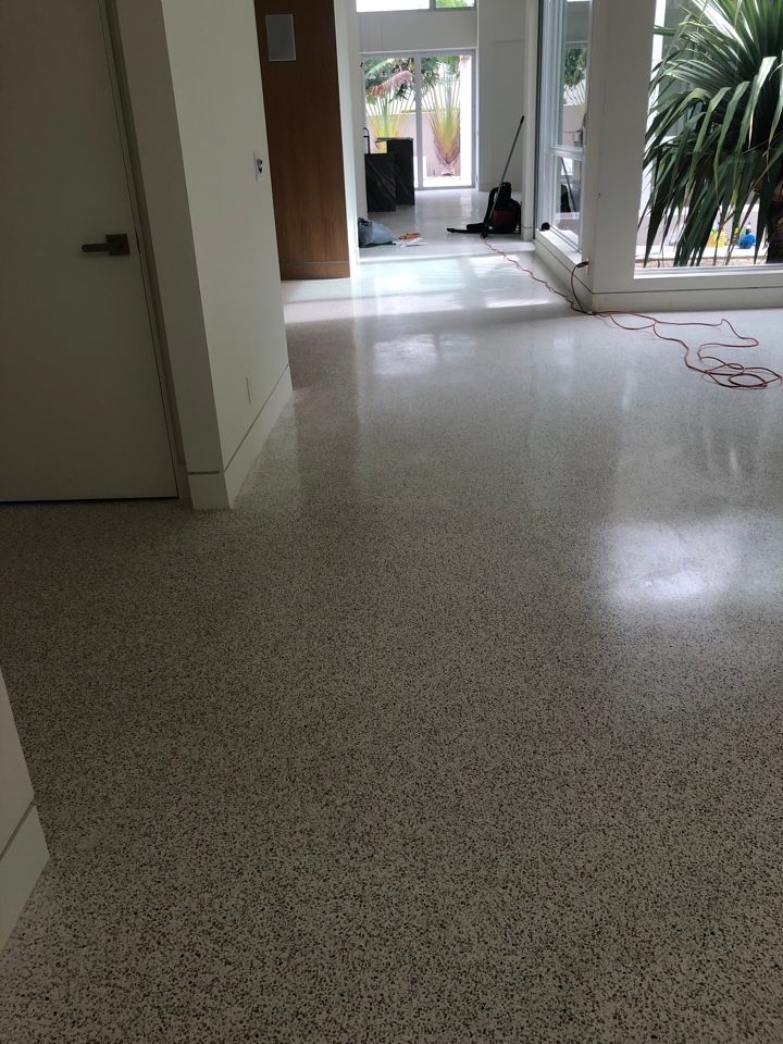 A living room with a white floor and a white door.