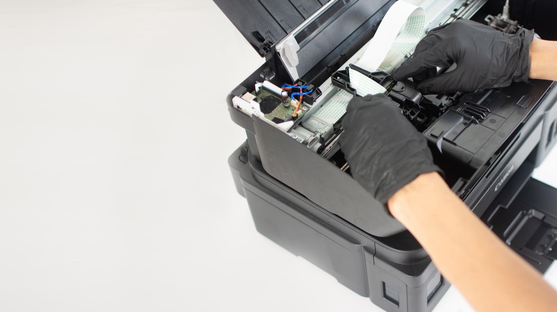 A Person Wearing Black Gloves Is Fixing a Printer — Ink n' Toner Forster in Pacific Palms, NSW