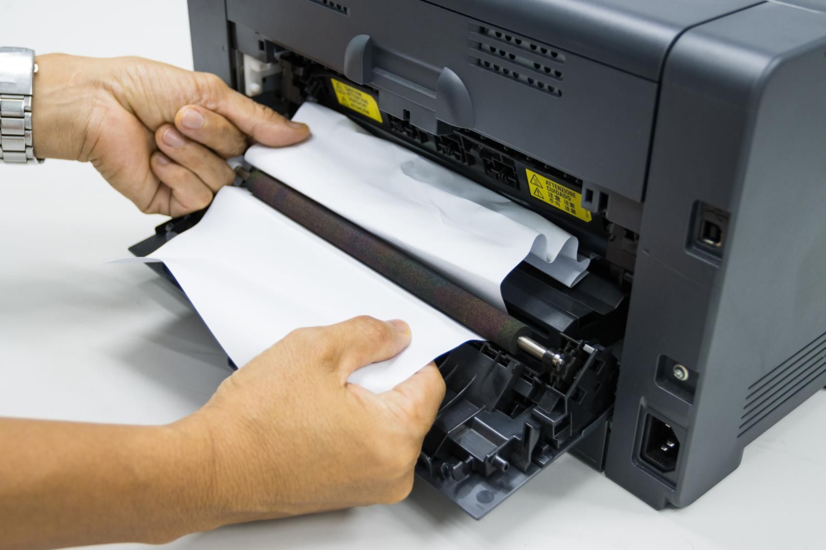 A Person Is Taking a Piece of Paper out Of a Printer — Ink n' Toner Forster in Taree, NSW