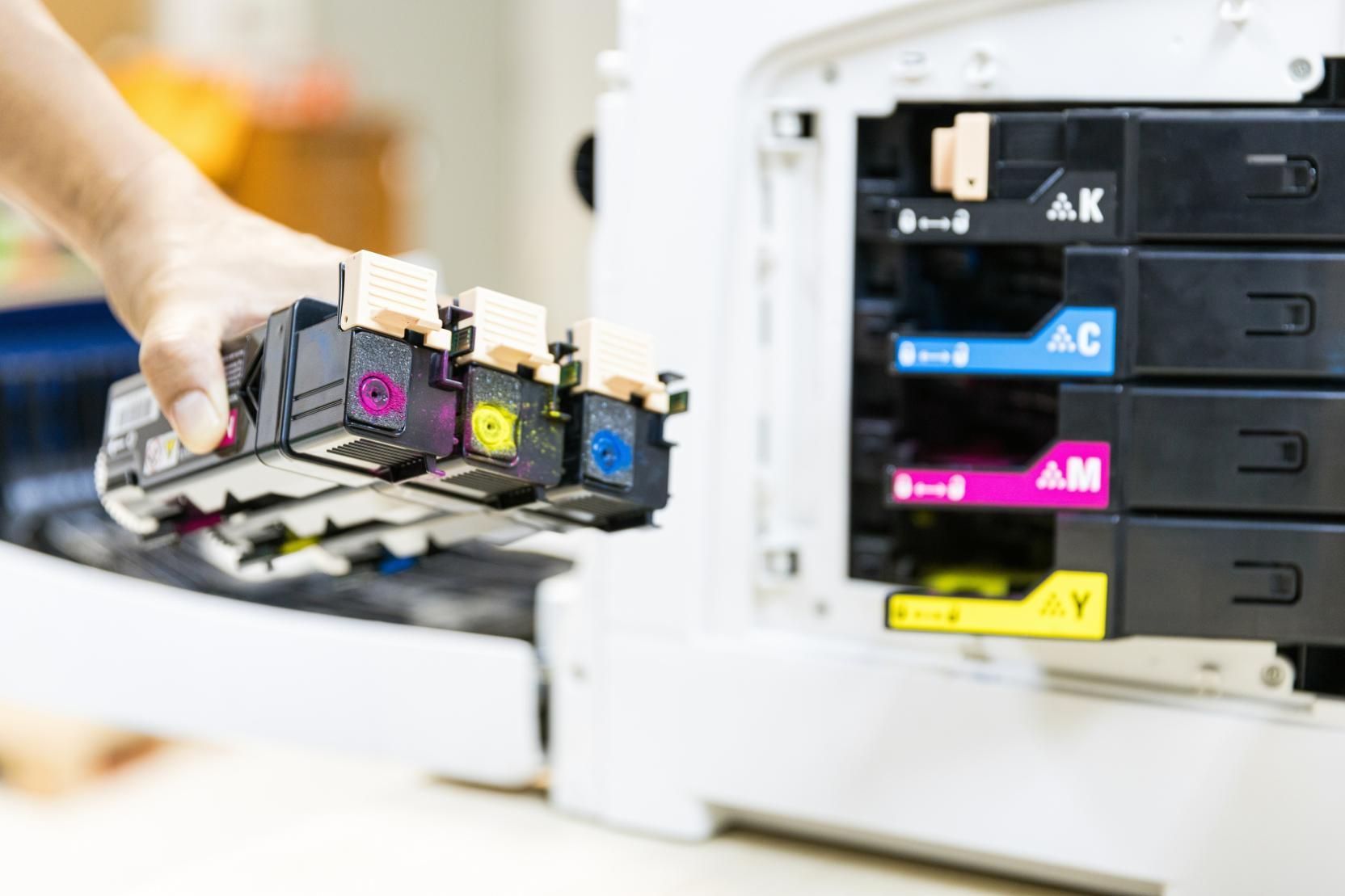 A Person Is Holding a Stack of Ink Cartridges — Ink n' Toner Forster in Old Bar, NSW