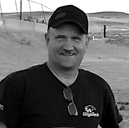 A black and white photo of an older man with a beard.