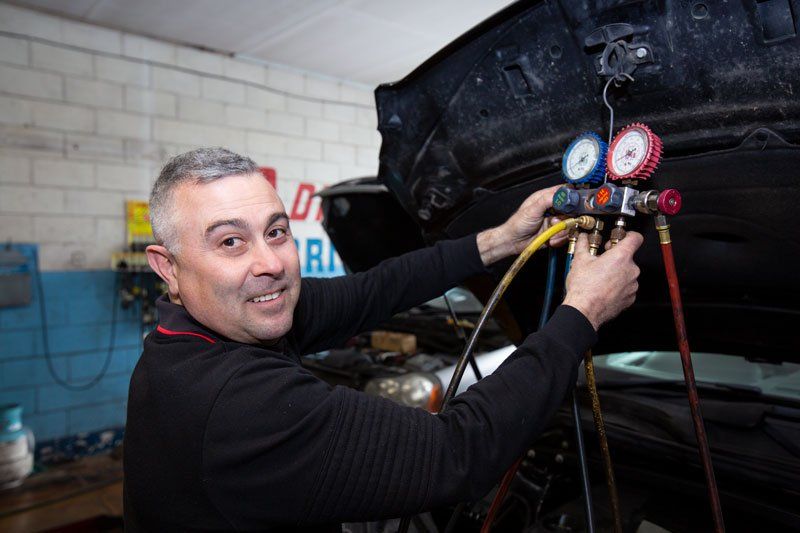 A Man Checking The Condition Of A Car - Adelaide, SA - Silver’s Auto Centre