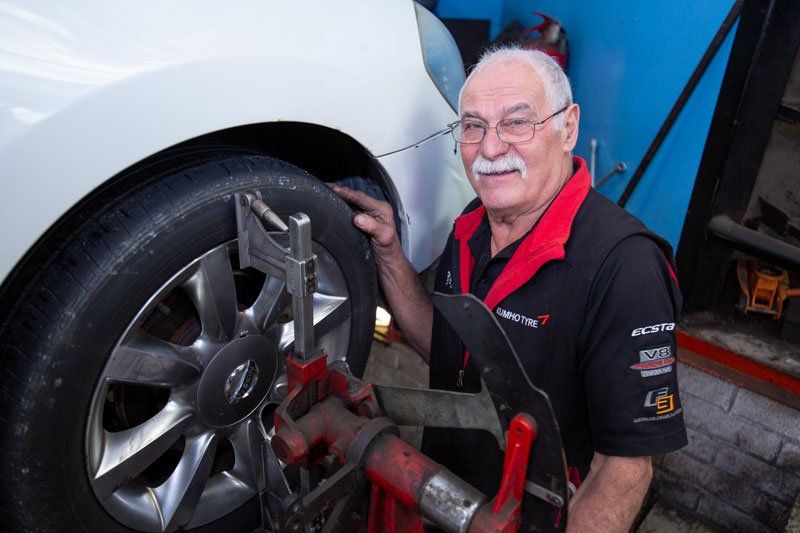 An Old Man Checking The Tyre  - Adelaide, SA - Silver’s Auto Centre