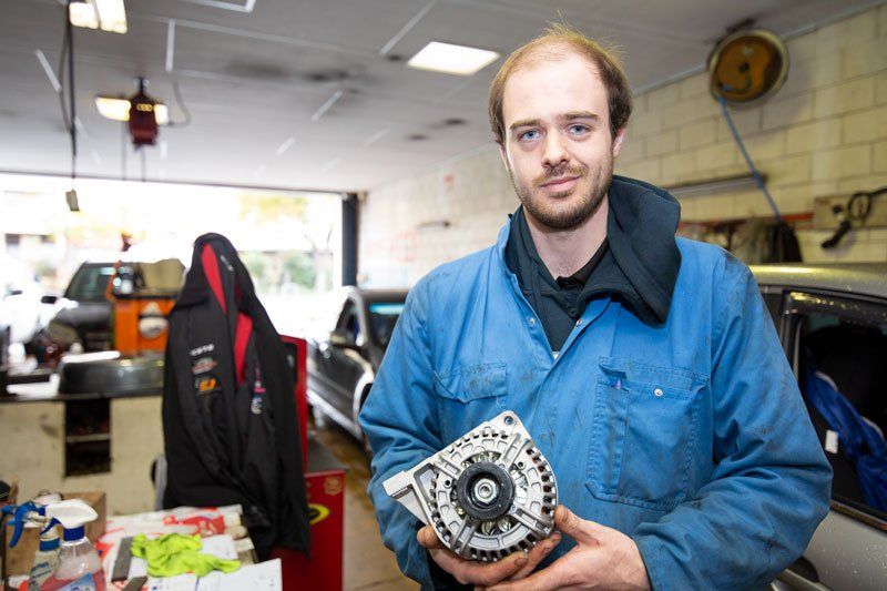 A Man Holding And Engine - Adelaide, SA - Silver’s Auto Centre